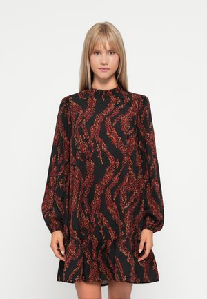 Robe noire à manches bouffantes longues, avec un col froncé et un ourlet à volants. Motif de feuilles rouges et oranges sur l'ensemble du tissu.