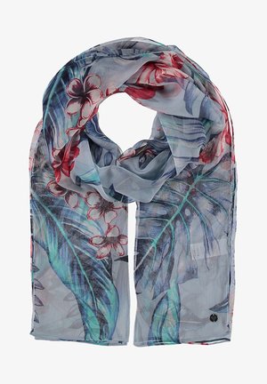 Foulard léger et transparent avec un motif de feuilles tropicales et de fleurs rouges dans des tons bleus, verts et rouges, plié légèrement avec une étiquette visible.