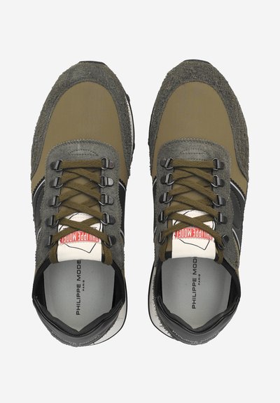 Tan and gray sneakers featuring a textured suede upper, black accents, round laces, and a logo on the insole. Lightweight design.