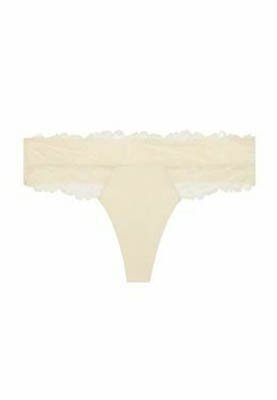 Beige blonder-bøg med bølget kant og et fint blomstermønster på taljebåndet.