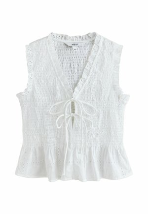 Hvid ærmeløs bomuldsbluse med smocket krop, hulmønsterkant, V-hals, bindedetalje foran og flæsekanter forneden.