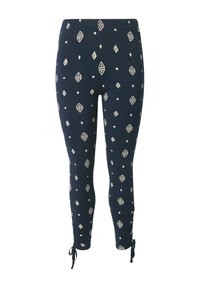 Granatowe legginsy z elastycznego materiału w białe geometryczne wzory. Posiadają zgromadzone mankiety z wiązaniami przy kostkach dla regulowanego dopasowania.