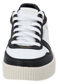 Skechers Court Classics sneaker in black and white leather with flat white laces, gold accents, and a ridged rubber sole.
