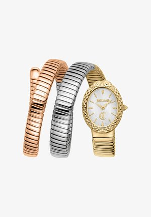 Montre ovale ton or avec lunette texturée et cadran blanc, attachée à un bracelet métallique enroulé tricolore aux tons rose, argent et or.