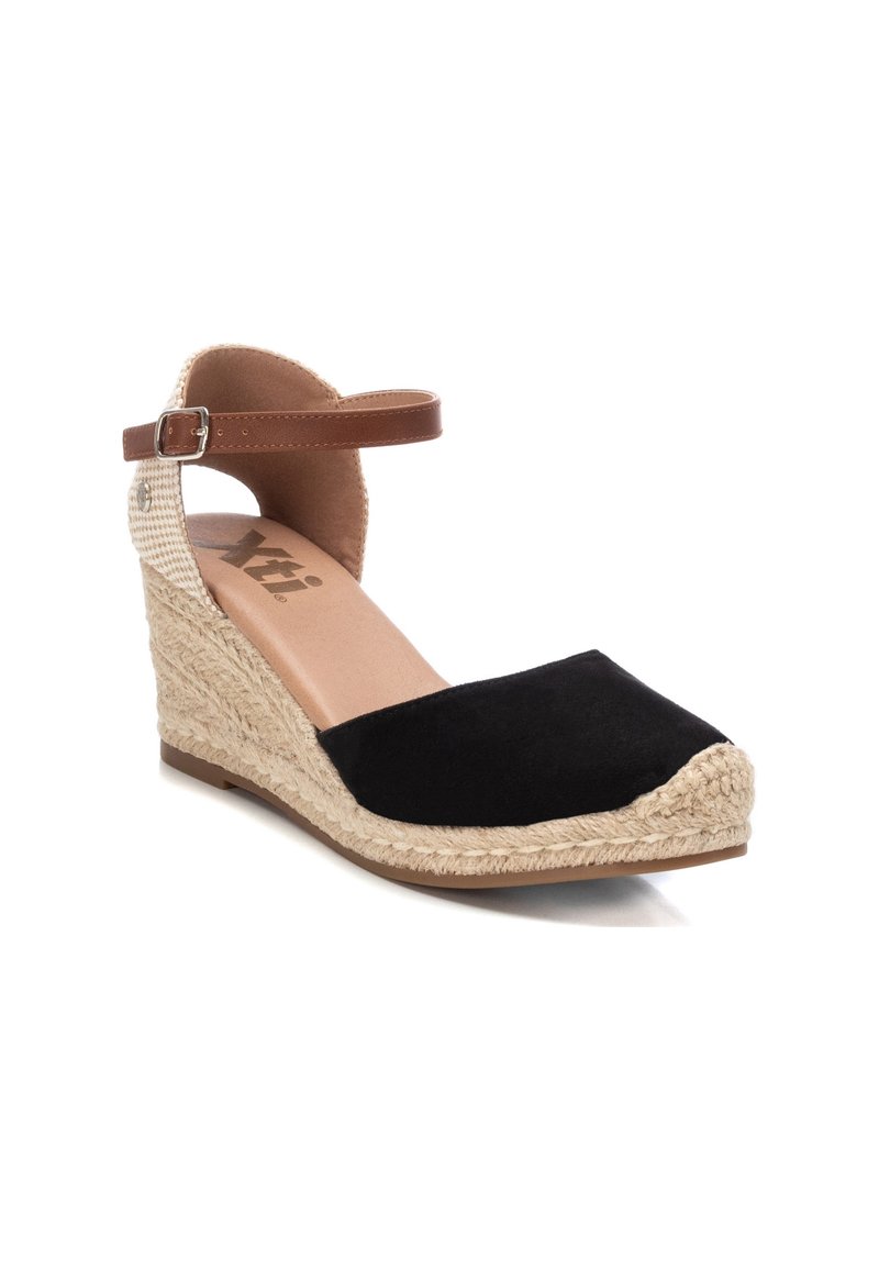 Black suede wedge shoe with an espadrille rope sole. Features a brown ankle strap with a buckle and a beige checkered detail.