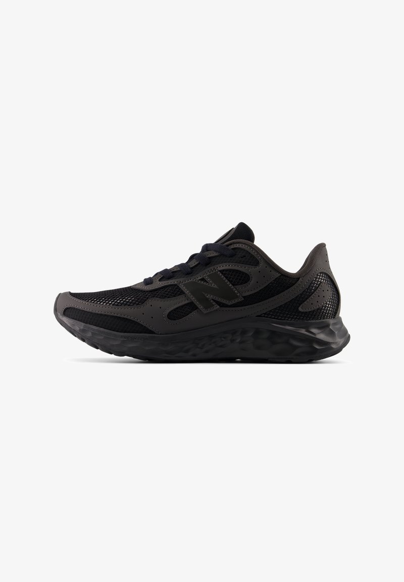 Black athletic shoe with mesh upper, synthetic overlays, lace fastening, and textured sole. Features a prominent logo on the side.