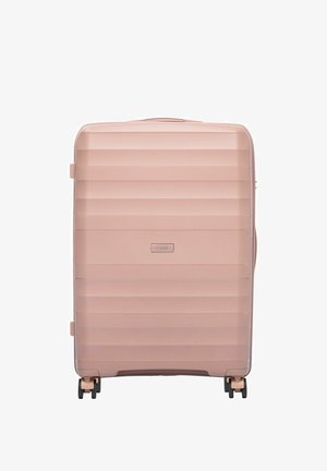 Duża prostokątna walizka twarda w stonowanym różowym kolorze z poziomymi rowkami, cztery czarne kółka i górny uchwyt.