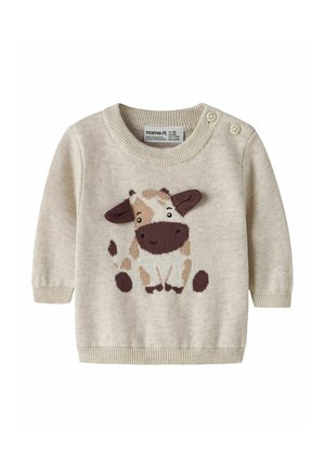 Beige babytrøje med strikket smilende ko-design på fronten og to knapper på skulderen for nem påklædning.
