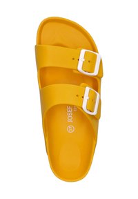 Yellow slip-on sandal with two adjustable white buckles, flat sole, and textured footbed, featuring branding and size printed inside.