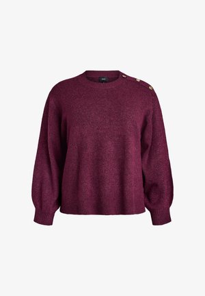 Burgundin värinen neulepaita, jossa on pyöreä kaula-aukkko, pitkät hihat, ribbaatut hihansuut ja kolme koristepainiketta vasemmalla olkapäällä. Pehmeä tekstuuri.
