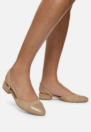 Beige leather slingback shoes with a flat heel, featuring a pointed toe and two-tone design with matte and patent finishes.