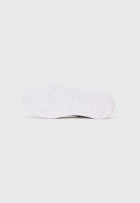 Weiße Sneaker-Sohle mit einem strukturierten Muster, das erhabene Kurven und Rillen für eine bessere Griffigkeit aufweist. Glattes Material, insgesamt runde Form.