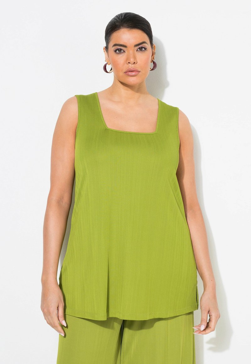 Top senza maniche di colore verde lime con scollatura quadrata. Realizzato in tessuto a coste, presenta una vestibilità ampia e rilassata che scende sotto i fianchi.