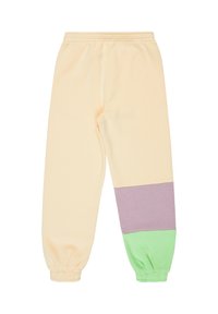 Licht perzikkleurige joggingbroek met een paarse horizontale streep en een groene boord. Voorzien van een elastische tailleband en boorden bij de enkels, gemaakt van zachte stof.