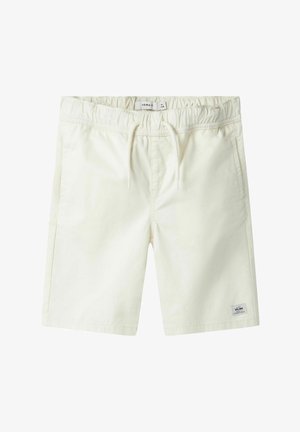 Shorts couleur crème en coton doux, dotés d'une taille élastique avec cordon de serrage, de poches latérales et d'un petit patch logo.
