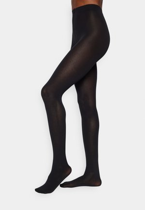 Meias opacas pretas com uma textura suave, apresentando uma cintura alta e um design sem costuras, afunilando até ao tornozelo ajustado.