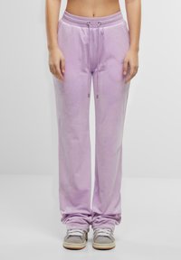 Lichtpaarse sweatpants van zacht materiaal, met een elastische tailleband met trekkoorden en een relaxed fit. Zilveren hardware accenten.