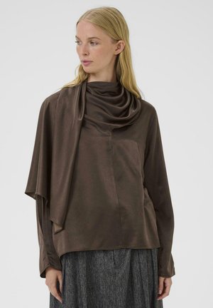 Top lungo a maniche lunghe in satin marrone con scollo a cowl drappeggiato e vestibilità rilassata, caratterizzato da una superficie liscia e cuciture minime.