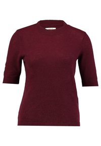 Burgundy lyhythihainen neulepusero pyöreällä kaula-aukolla. Neulottu pintakuvio, jossa ribbireunat hihoissa ja helmassa, tarjoaa rentoa ja istuvaa ilmettä.