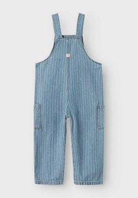 Denimoveraller i ljusblått med vertikala vita ränder, justerbara axelremmar, sidofickor och en liten logotypapplikation framtill.