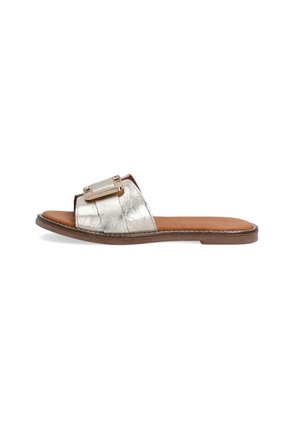 Silver metallic slide sandal with a wide strap featuring a rectangular buckle, a brown leather footbed, and a flat sole.