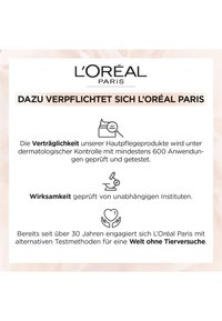 L'Oréal Paris varumärke på en övervägande vit bakgrund med ljusrosa accenter. Texten betonar produktens åtagande till dermatologiska tester och djurfria metoder.