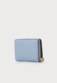 Light blue textured leather wallet with a gold zipper pull, featuring a smooth surface and a rectangular shape. Minimalist design.
