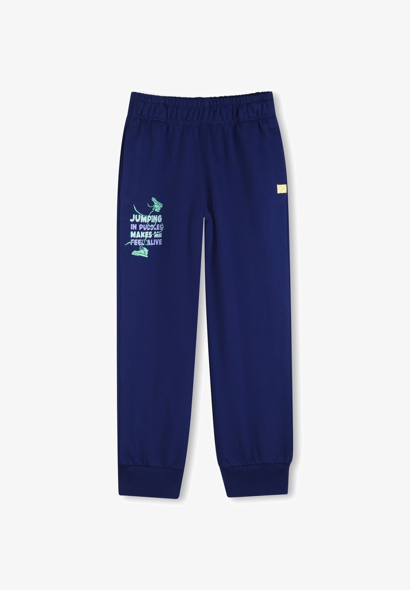 Pantalon de survêtement bleu marine avec taille à cordon, poignets élastiques, et un texte graphique vert accompagné d'un dessin de chaussure et d'une phrase sur la jambe gauche.