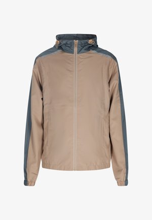 Letvægts, beige vindjakke med hætte. Har grå detaljer på skuldre og ærmer, elastiske manchetter og en frontlynlås.