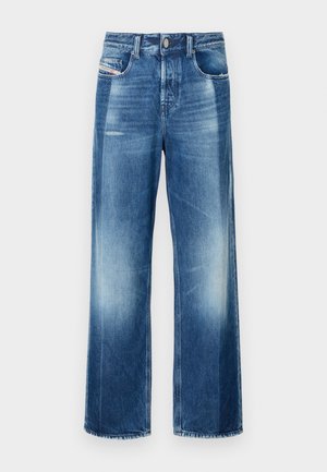 Wide-leg denim jeans in medium blue, featuring a button closure, front pockets, and slight fading. Clean hem with a straight cut.