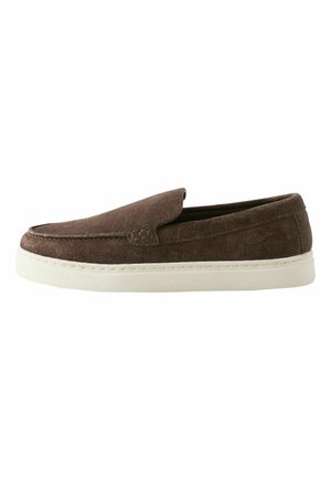 Brown suede slip-on shoe with white rubber sole, flat design, and simple stitch detailing along the upper edge.