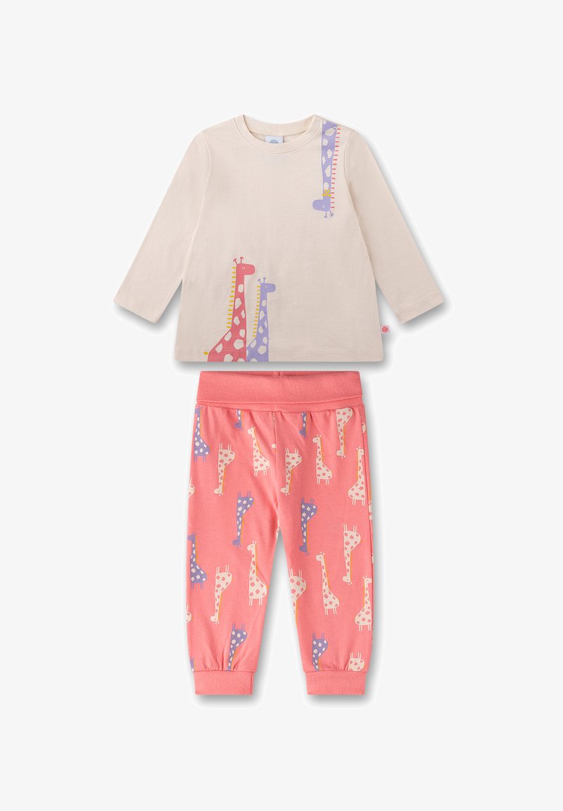 Light beige long-sleeve shirt featuring colorful giraffe prints; coral pants with repeated giraffe pattern; cotton material; relaxed fit.