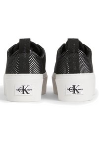 Svarta nät sneakers med vita gummisulor, med en logotyp på varje häl, texturerade detaljer och dragflikar för enkel p åtagning.