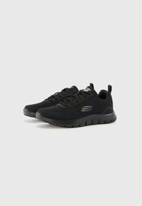Black athletic shoes with a breathable mesh upper, lace-up design, padded collar, and a flexible rubber sole with a textured grip pattern.
