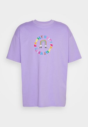 Lavender cotton t-shirt with a round graphic featuring a rainbow and “FAMILY UNITY” in colorful letters. Short sleeves and crew neck design.