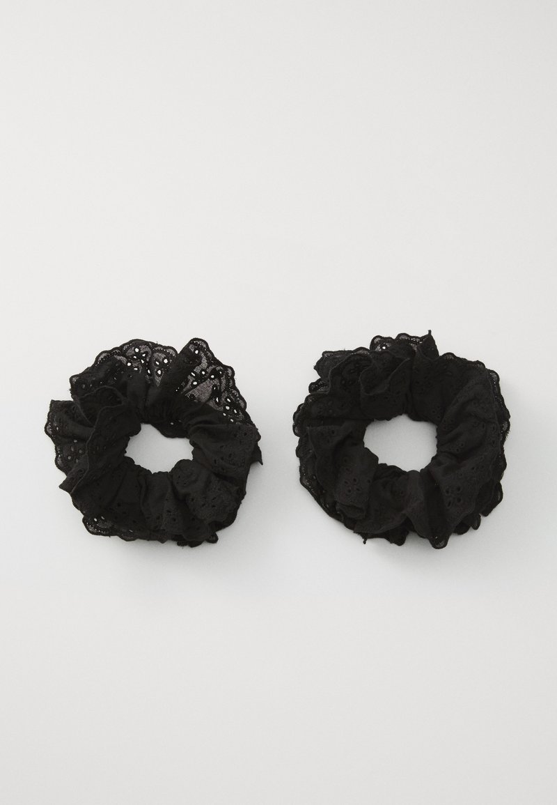 Black fabric scrunchies with a ruffled texture, featuring eyelet patterns. Two sizes, both soft, with a delicate finish.
