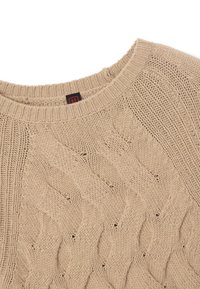 Maglione beige a maglia con un design testurizzato e una scollatura rotonda a costine. Il tessuto sembra morbido con dettagli di cucitura visibili.