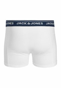 Boxers blancs pour hommes avec ceinture bleu marine affichant le logo "JACK & JONES" en blanc, vus de dos.