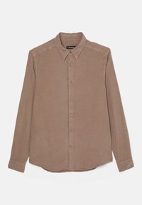 Camisa marrón de manga larga hecha de tela suave. Cuenta con un cuello clásico, cierre frontal con botones y un logo sutil cerca del dobladillo.