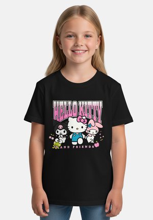 Smiling girl wearing a black T-shirt with Hello Kitty and friends characters and pink lettering on the front.