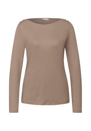 Dlouhý rukáv, béžový vršek z měkké látky s širokým lodičkovým výstřihem a dvěma dekorativními knoflíky na ramenou. Hladká textury, ležérní střih.