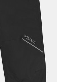 TROLLKIDS LOFOTEN RAIN UNISEX - Kalhoty do deště - black