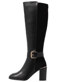 Black knee-high boots made from smooth leather and suede, featuring a chunky heel and a buckle accent on the strap.