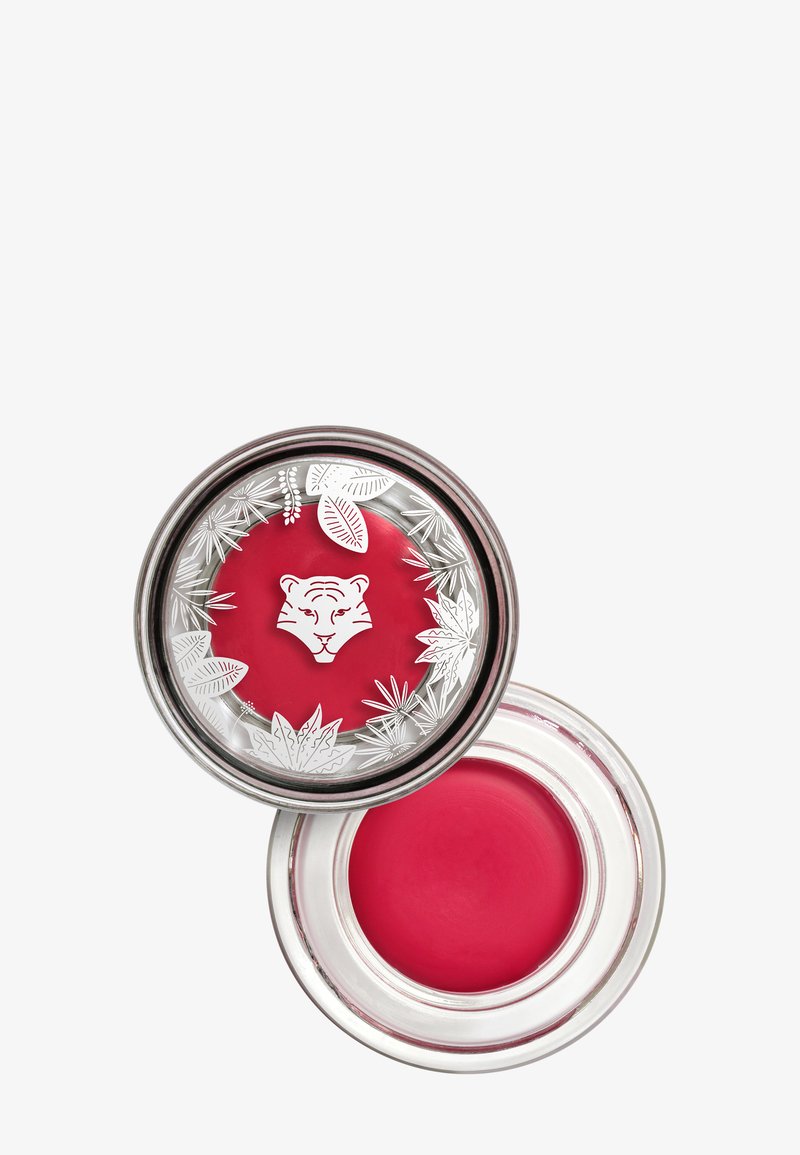 Ronde glazen verpakking met een zilveren deksel, gevuld met een roze crèmeproduct. Deksel versierd met een tijgerillustratie en botanische patronen.