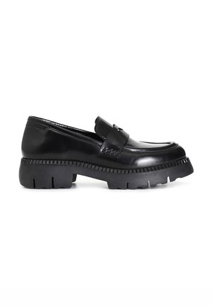 Black loafers with a glossy patent finish, chunky rubber sole, and decorative strap across the vamp. The sole features a serrated edge.