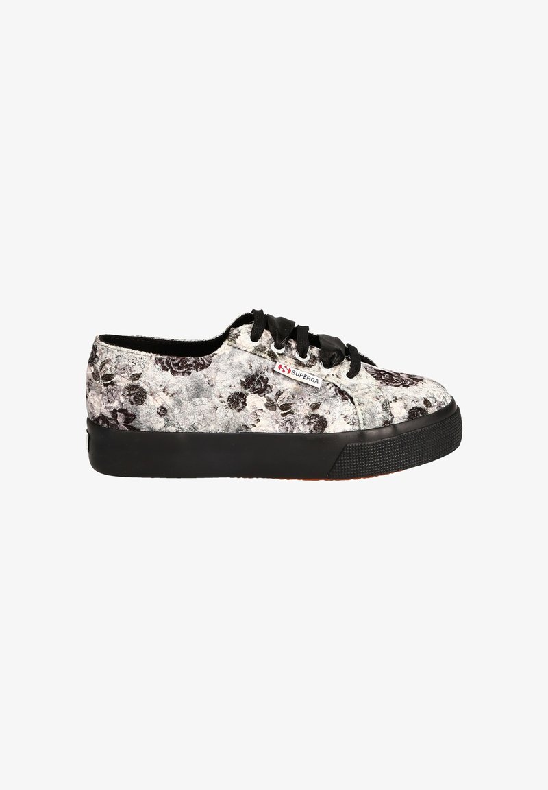 Black and white floral canvas sneakers with a textured upper, black rubber sole, and black laces. Features a red logo label on the side.