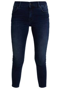 Tummansinisiä kapeita farkkuja, joissa on keskimäinen vyötärö, viisi taskua ja klassinen nappisuljenta.