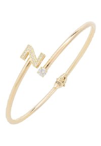 Gold-tone bangle bracelet featuring a diamond-studded letter "N" and a small round stone, with a textured finish. Adjustable clasp closure.