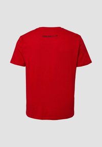 Rotes T-Shirt mit kurzen Ärmeln, von hinten gezeigt, mit kleinem schwarzen Text nahe dem Halsausschnitt auf einem schlichten hellgrauen Hintergrund.