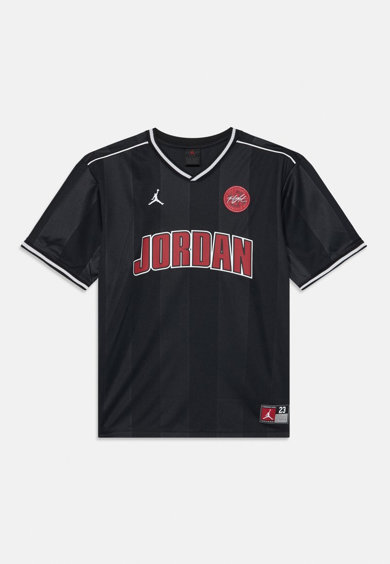 Black basketball jersey with red "JORDAN" text, white Jumpman logo, red circular patch, and white-striped collar and sleeve cuffs.